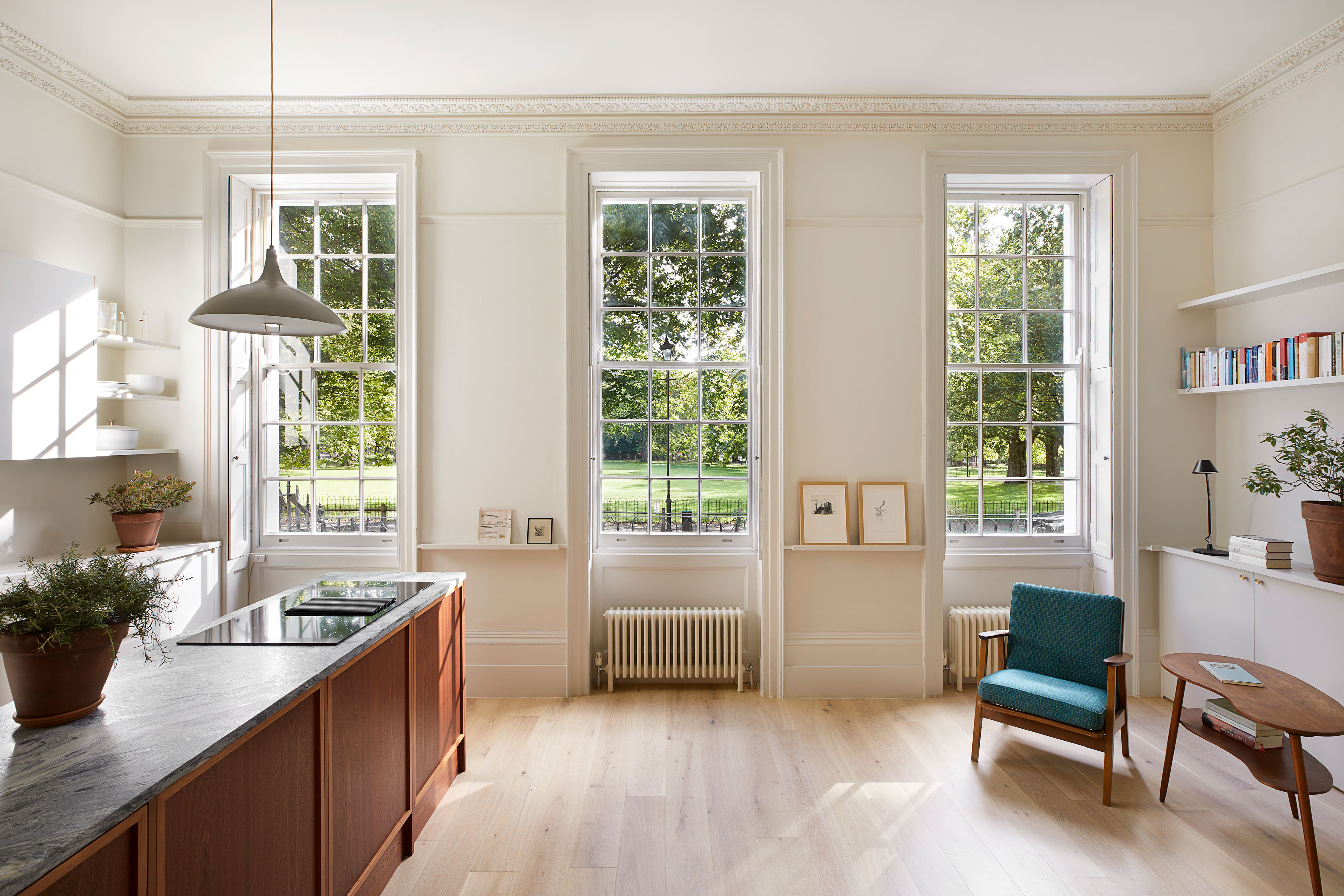 Room scene with kitchen large windows and chair