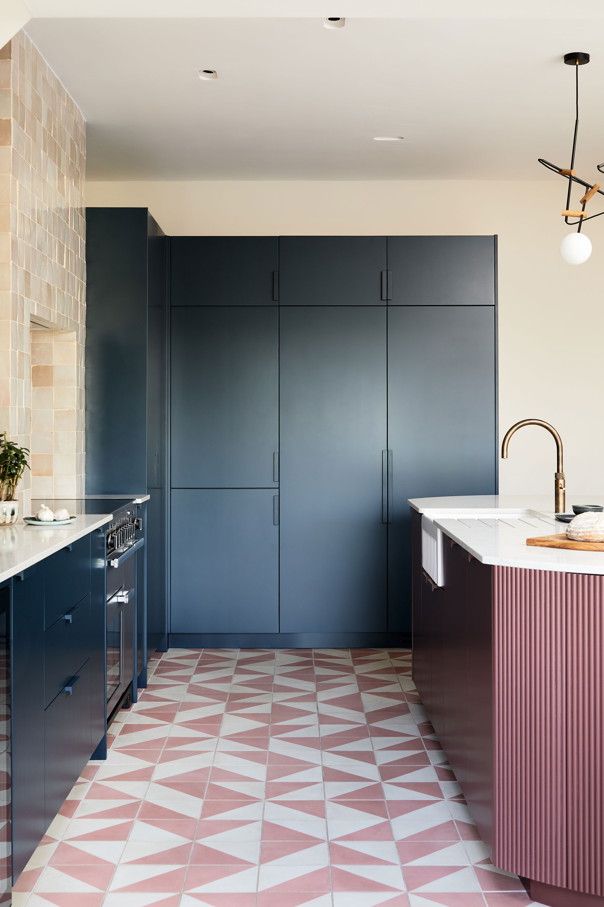 Blue kitchen, tiled floor and sink on island