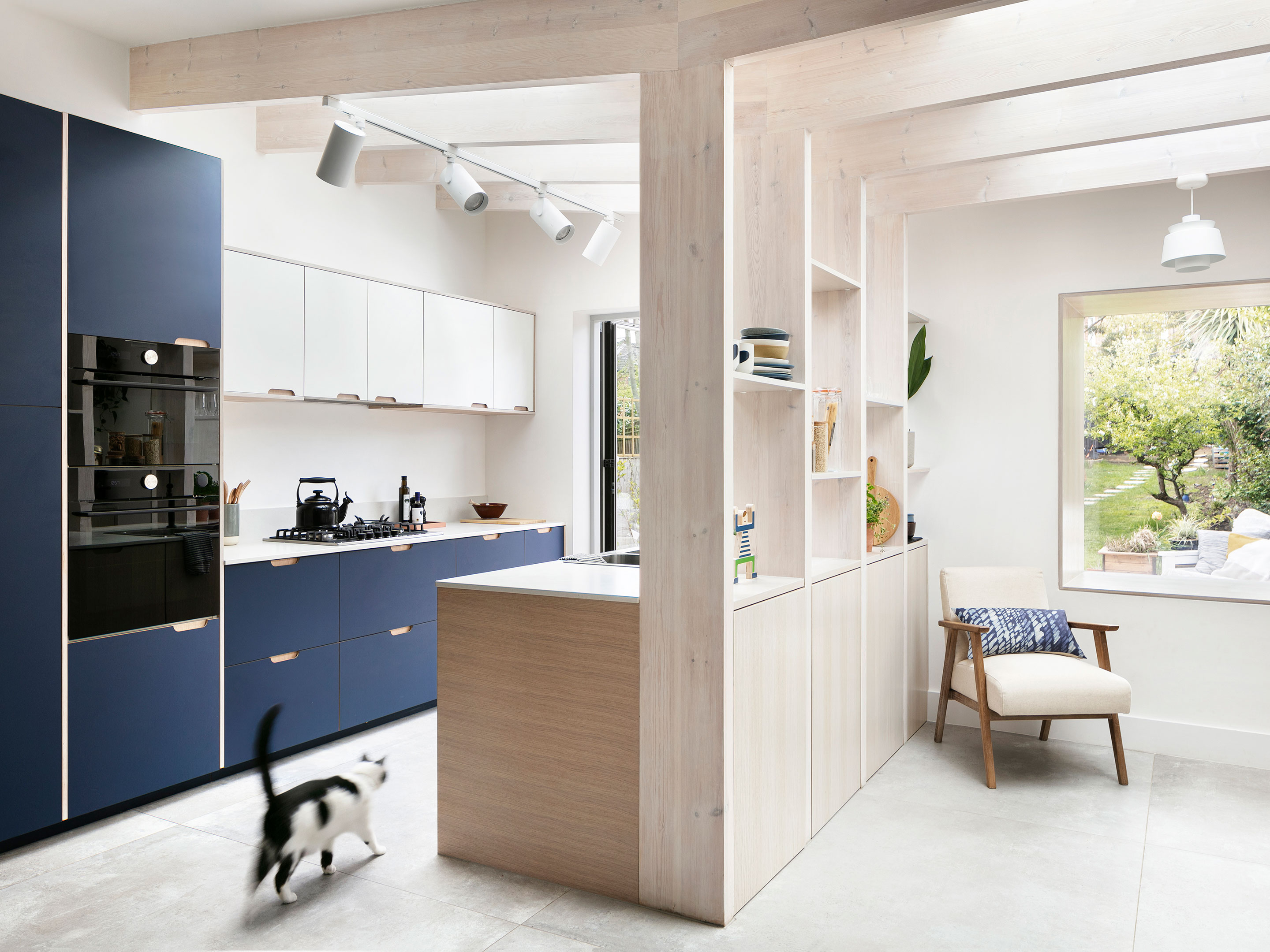 Blue kitchen, shelf divide and wooden ceiling beams