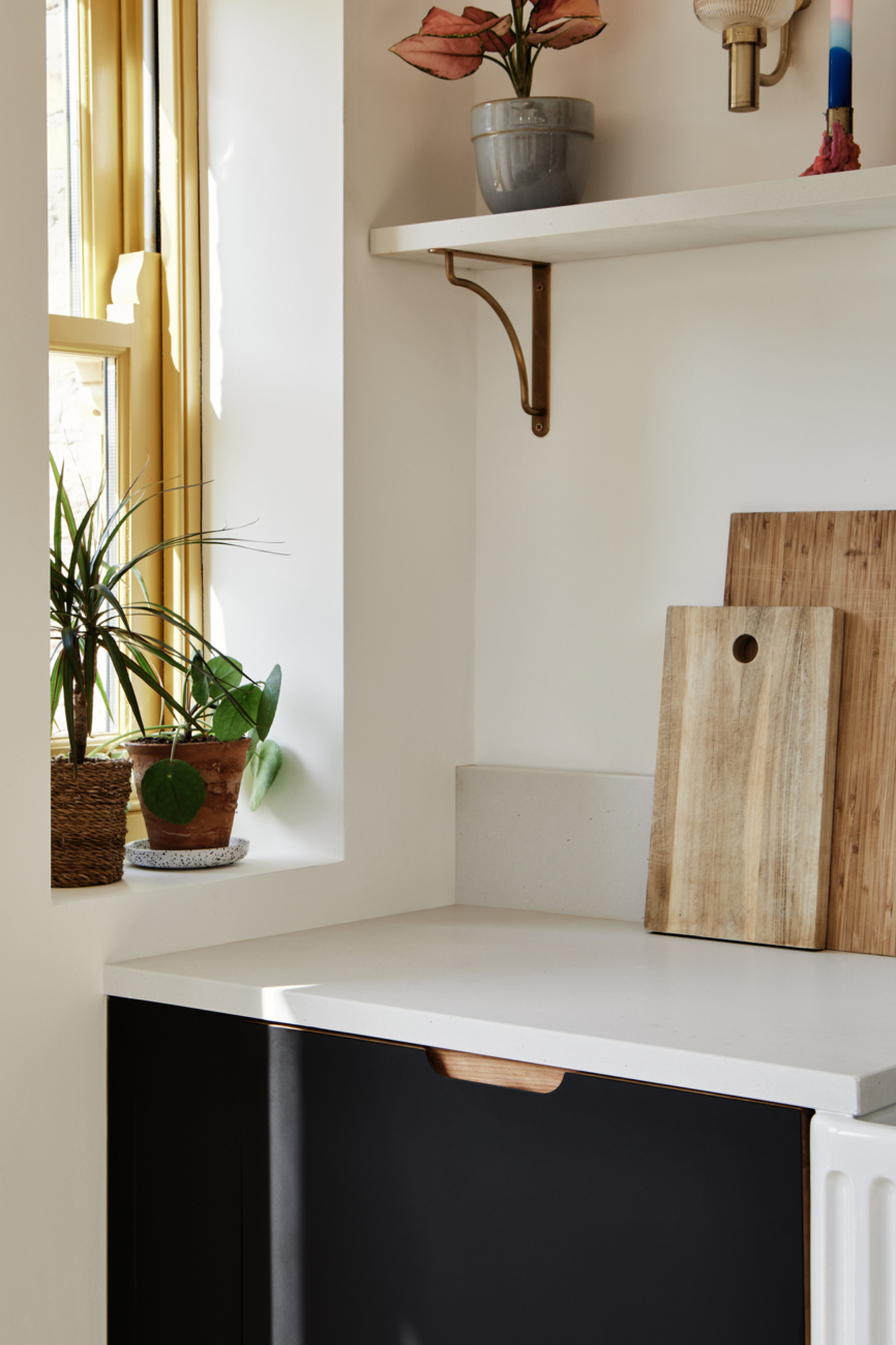 yellow frame window and white worktop with chopping boards
