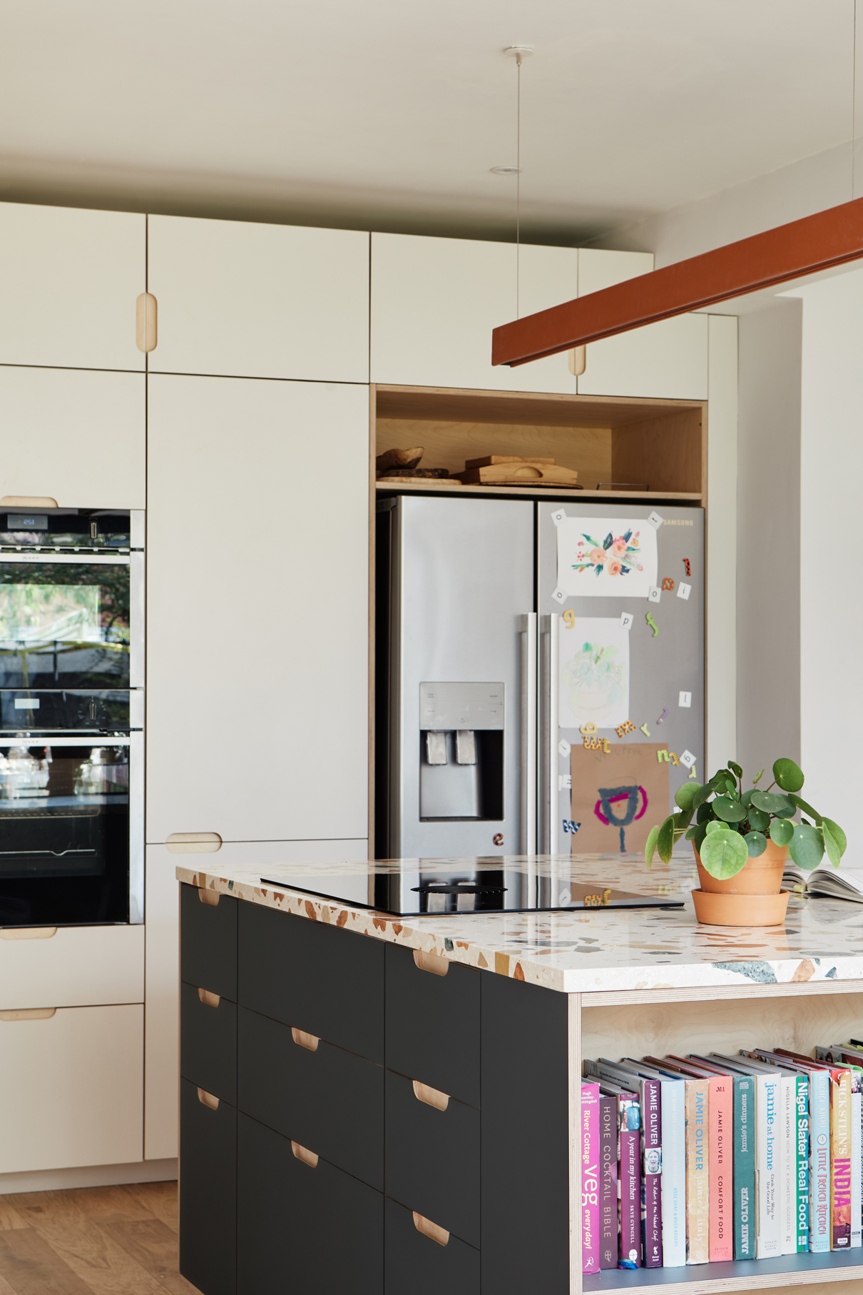 white cupboards with dark green island unit
