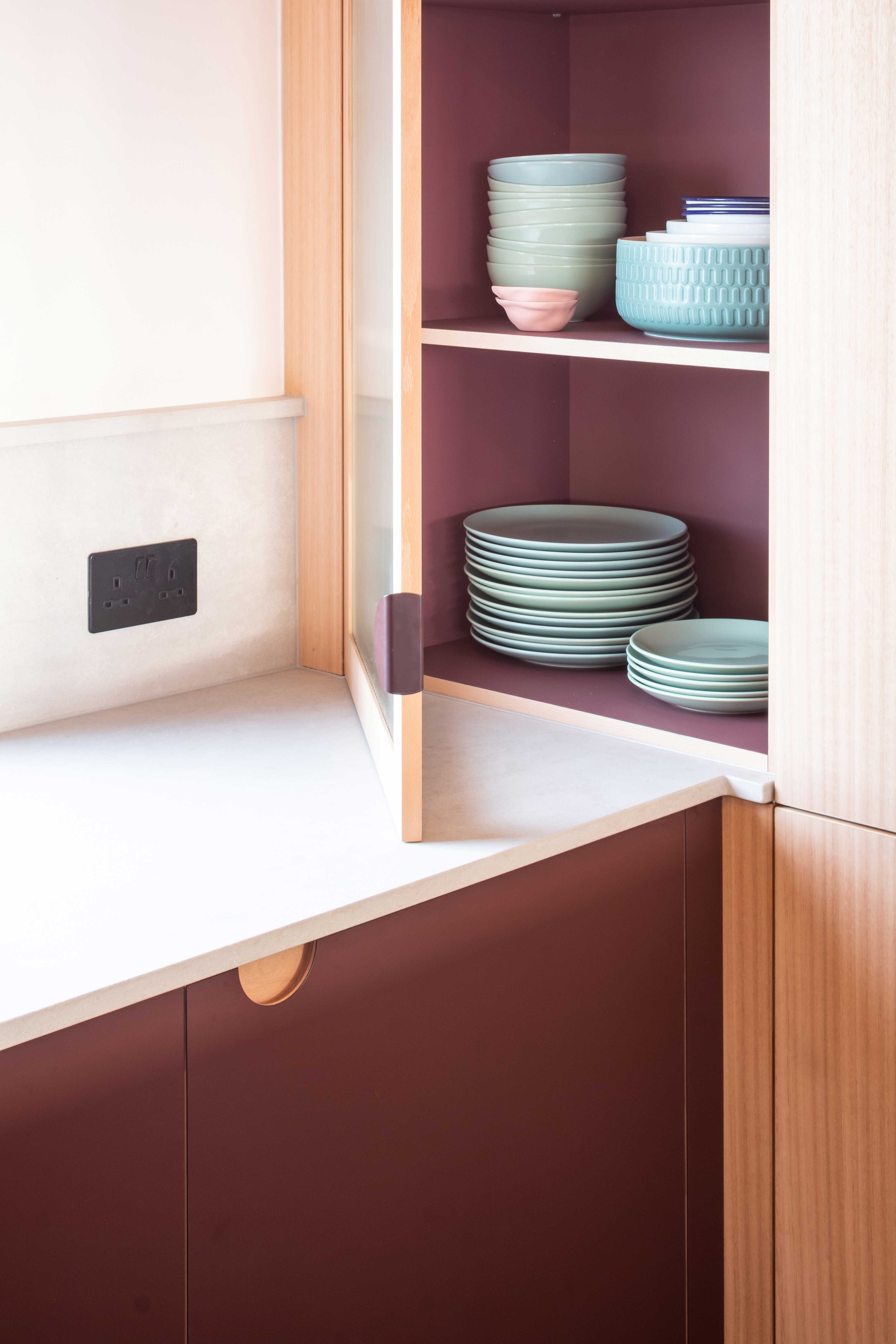 wood kitchen white worktop red doors hanging pendant lights