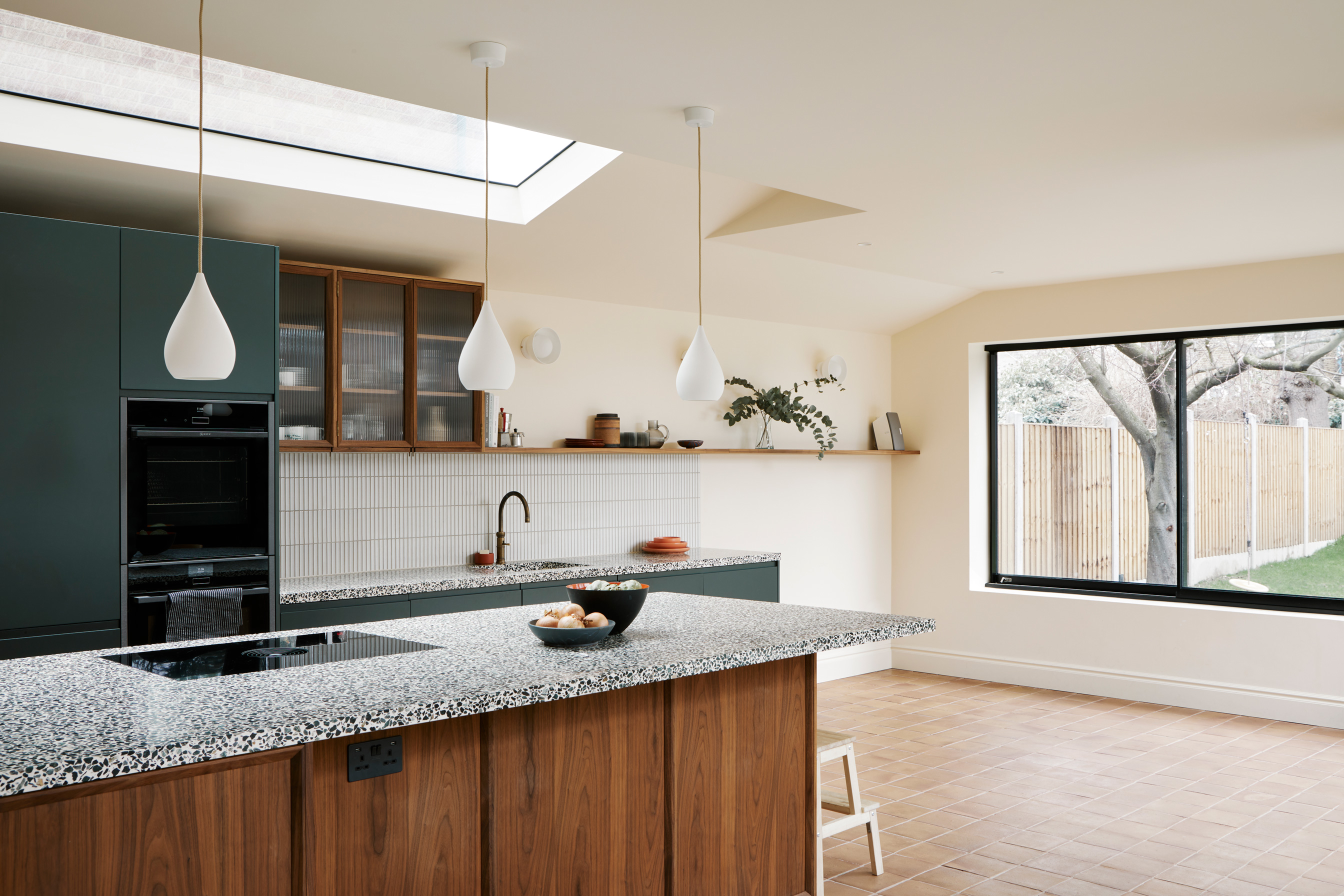 green and wood cabinets skylights and large windows
