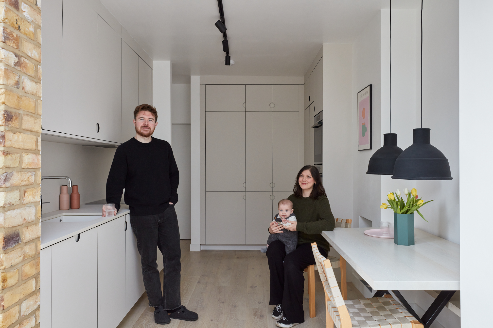family sat in white kitchen