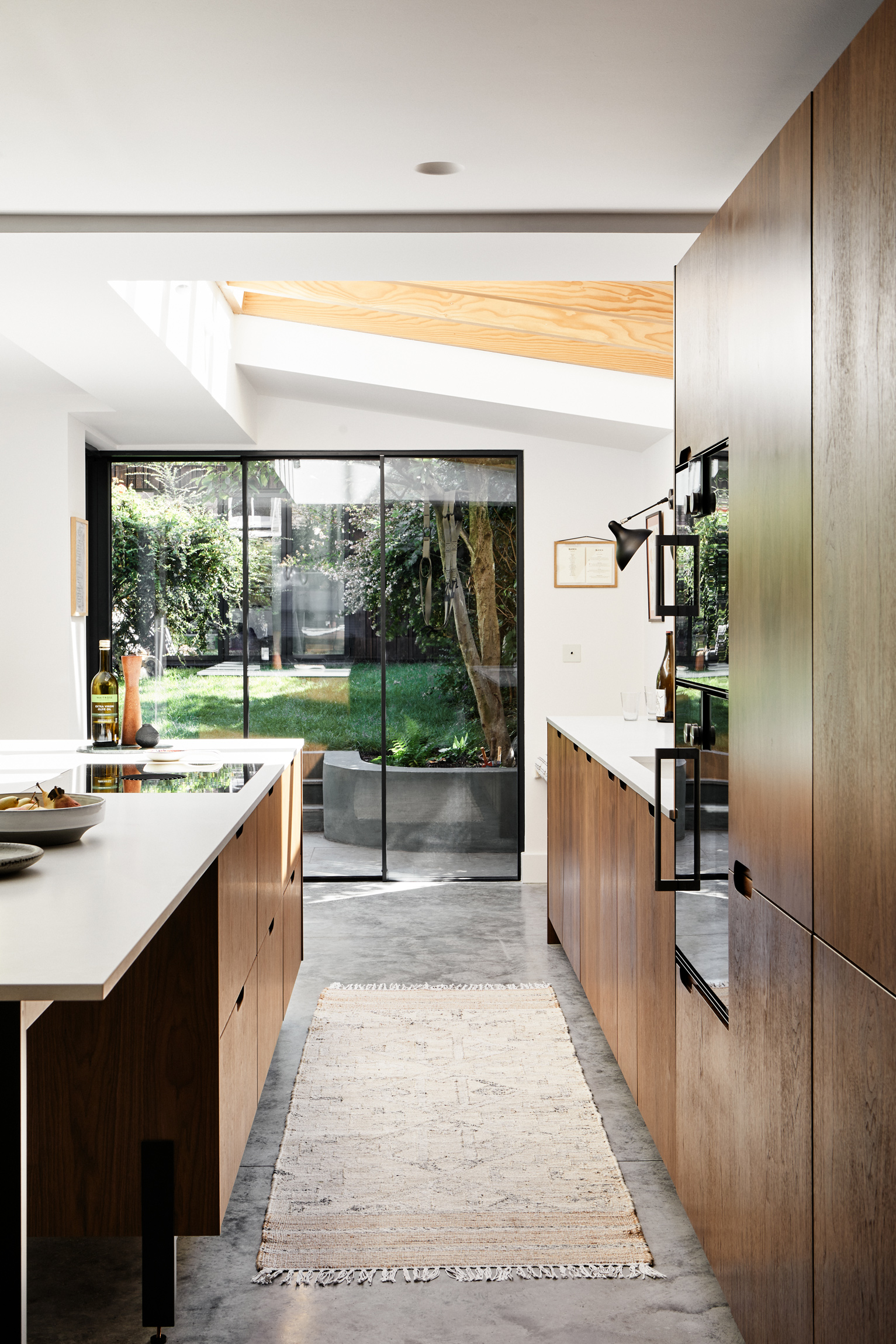 Walnut dark wood kitchen with white worktops