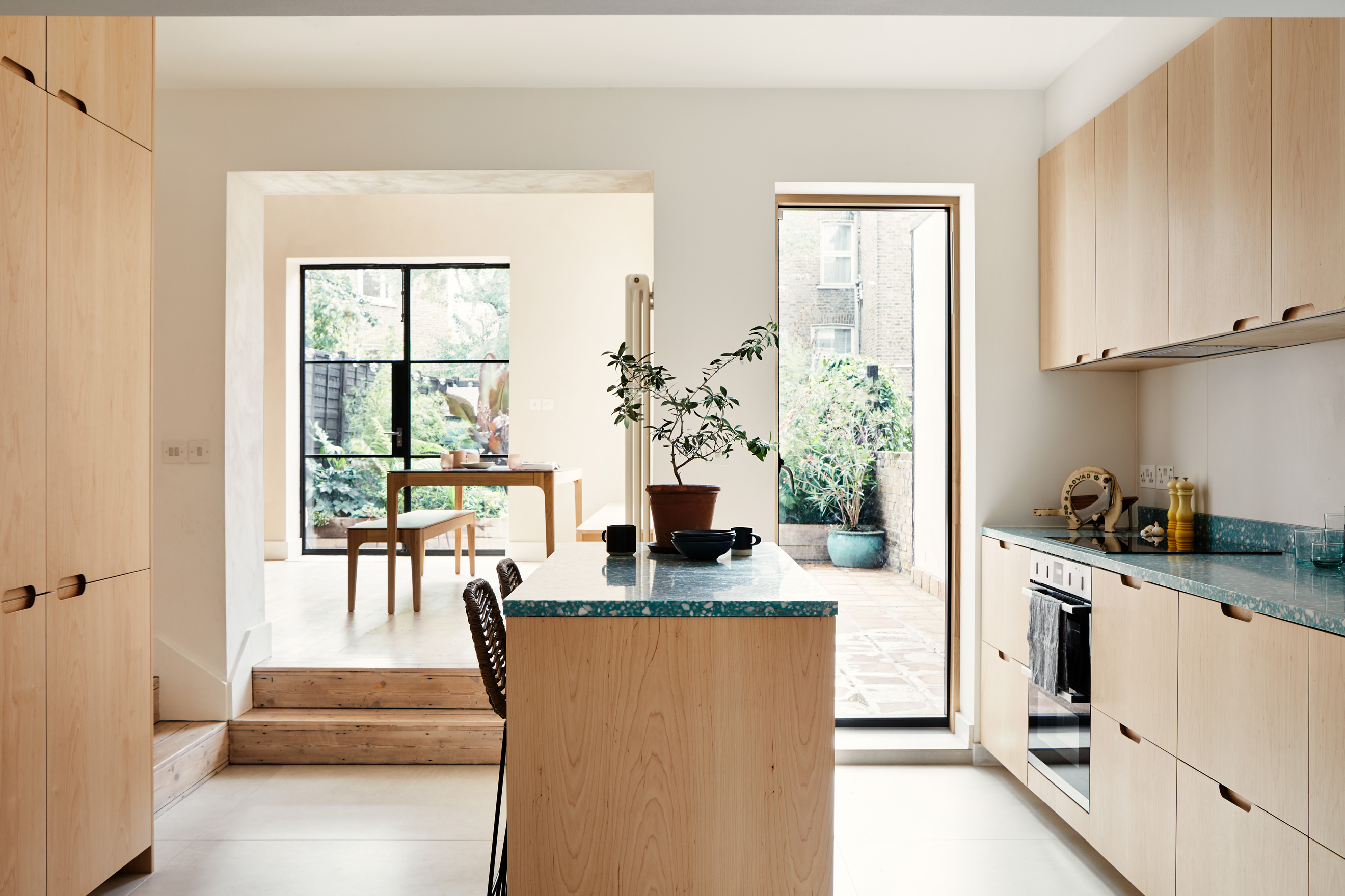 wooden kitchen with island and rood to back dining room