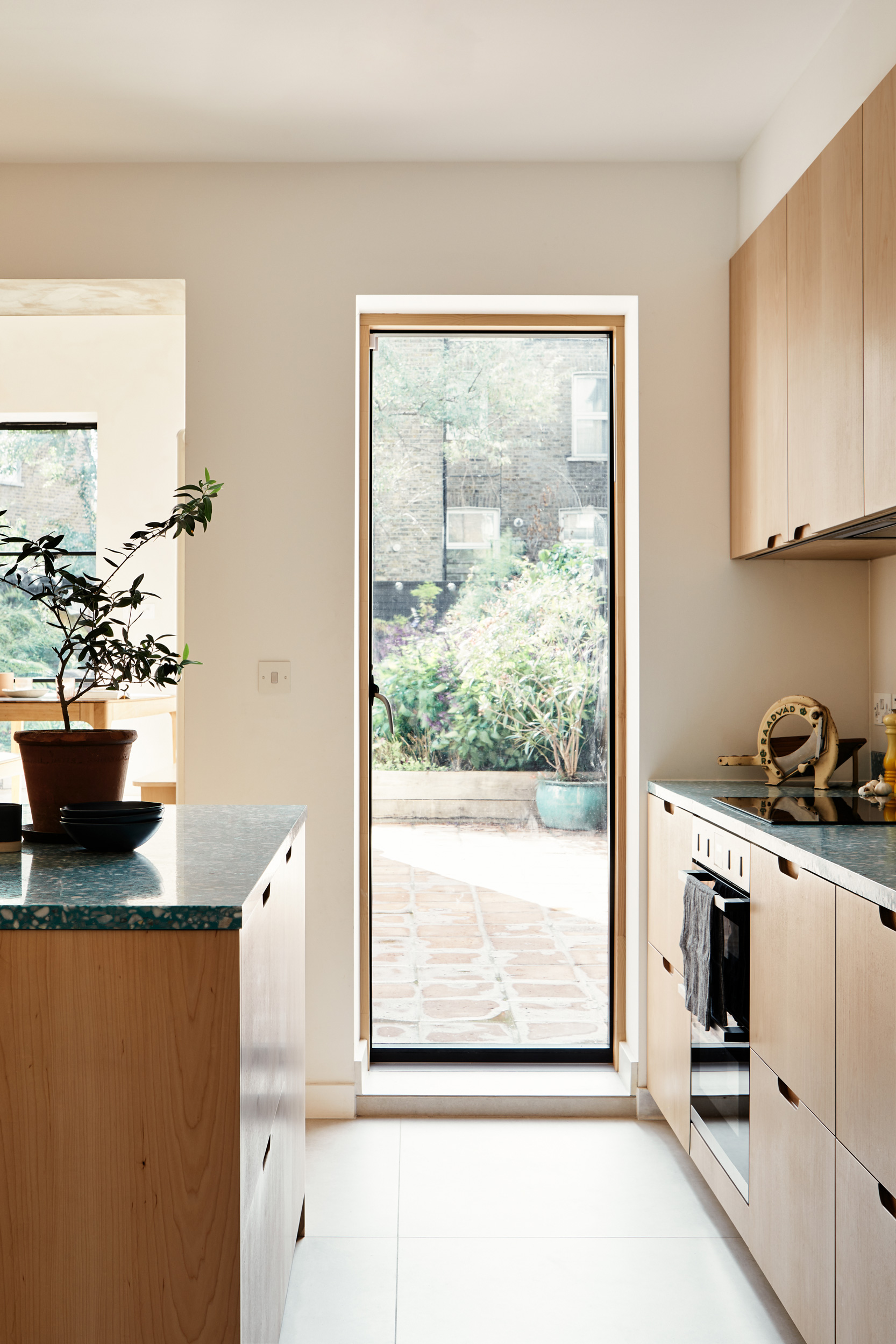 wooden kitchen with large window view to garden