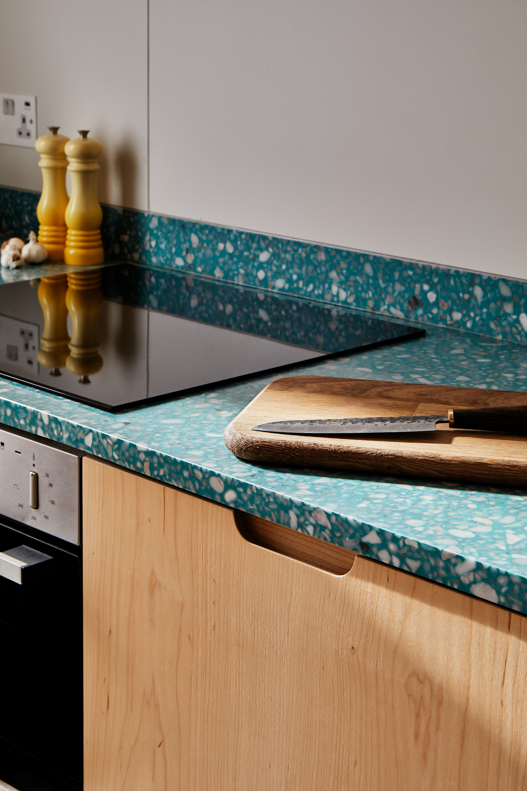 green worktop with wooden cupboards