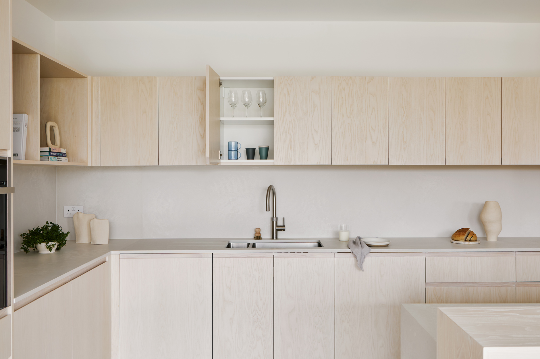 open plan kitchen with wood doors and white worktop