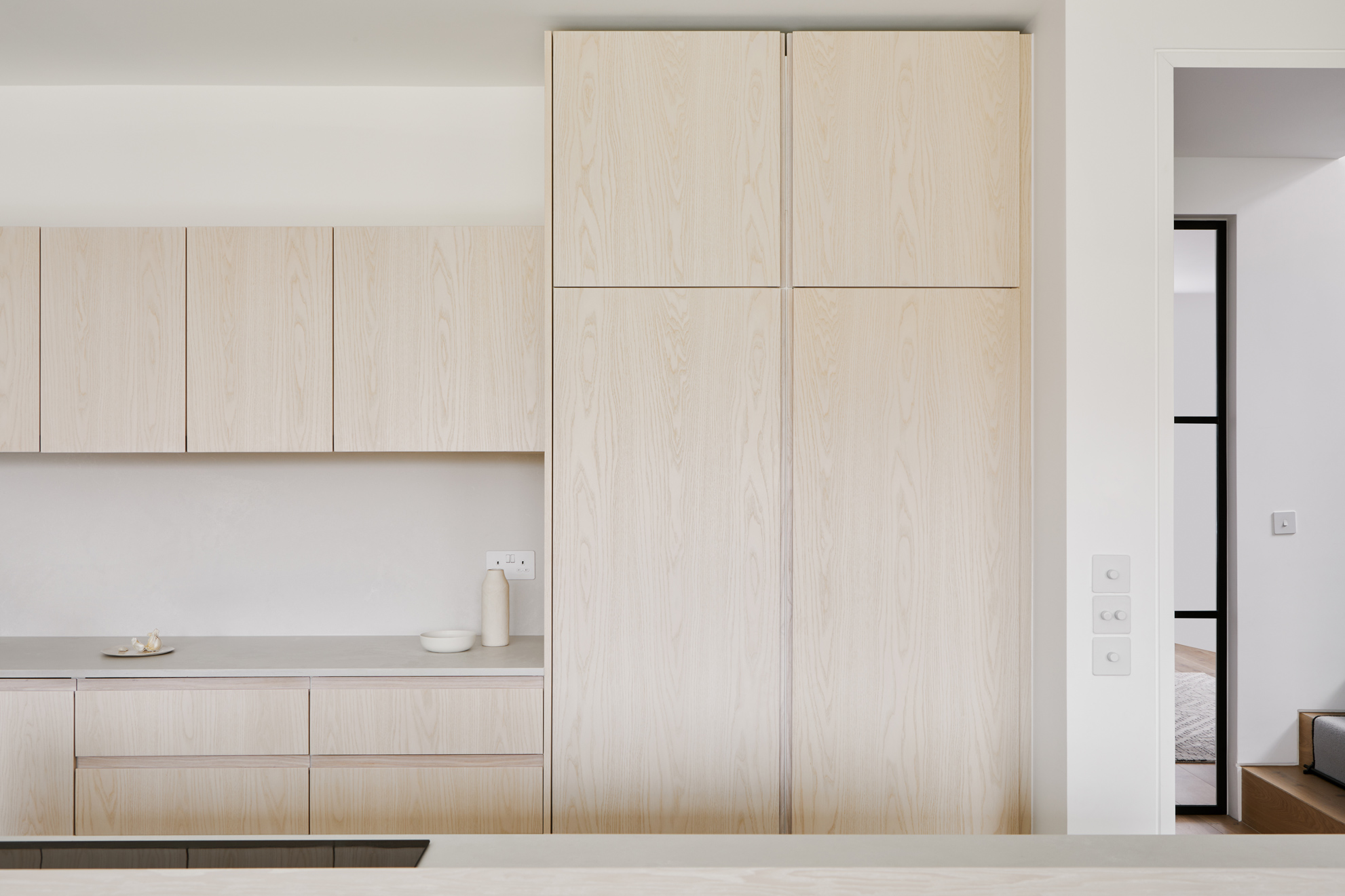 open plan kitchen with wood doors and white worktop