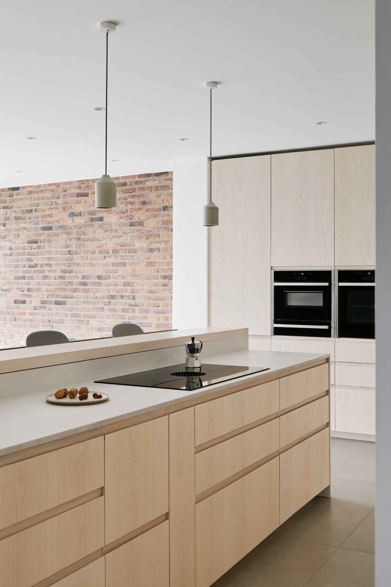 open plan kitchen with wood doors and white worktop