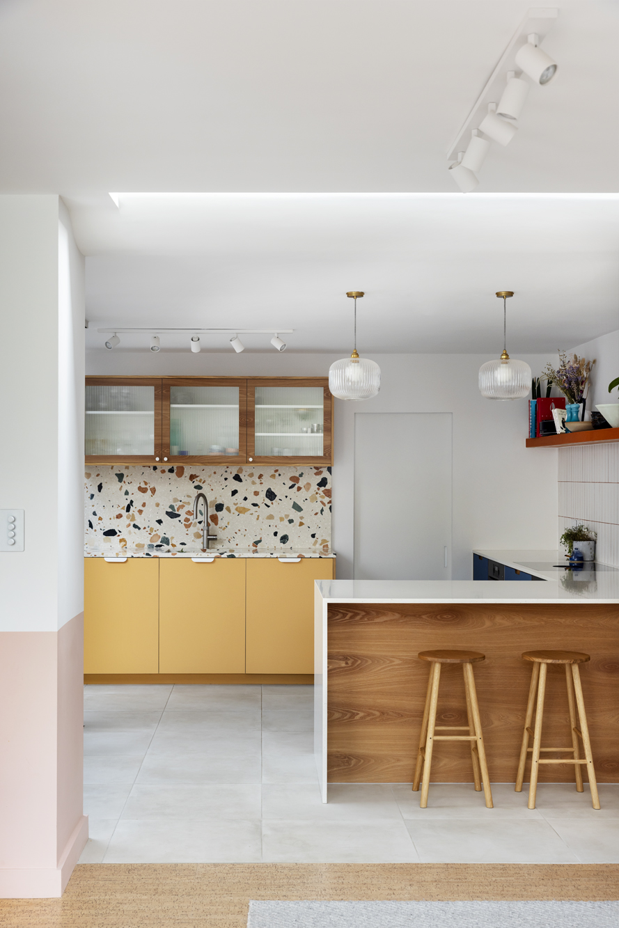 pink white and yellow kitchen with courtyard